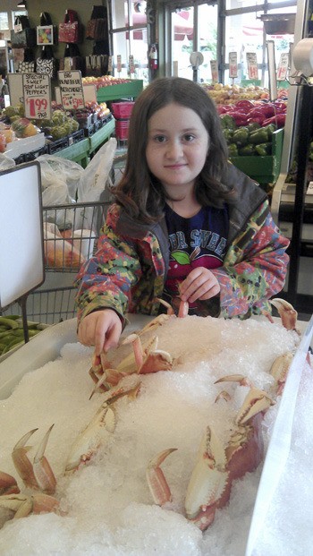 Amelia Ossorio checks out the crabs at Gemini Fish Market.