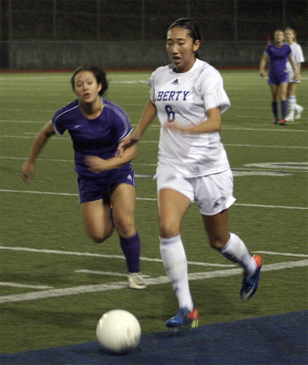 Liberty's Kimi Fry brings the ball up against Columbia River Nov. 9.