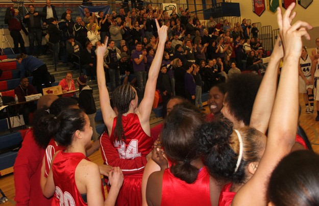 The Renton girls basketball team celebrates their victory over Sumner