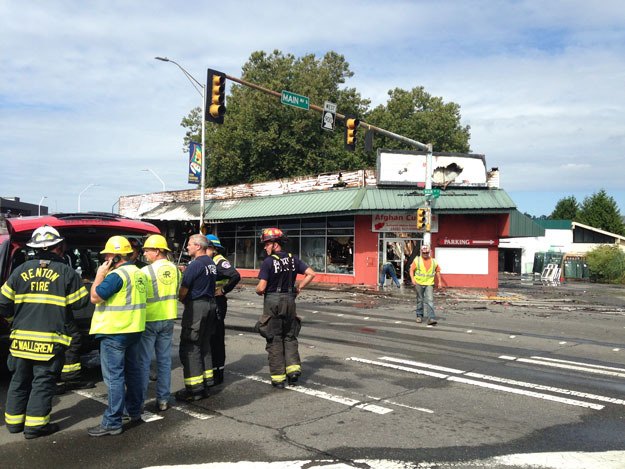 Firefighters and city staff on the scene of a two-alarm fire downtown on July 23.