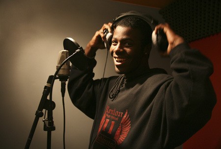 Louis Brown sings in the recording booth at Cry Out