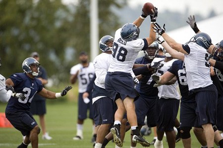 Seahawks defensive end Nick Reed intercepts a pass in training camp last year.
