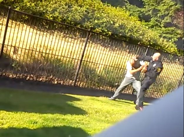 A screen shot of the first few seconds of a YouTube video shows a Renton police officer fighting with a suspect.