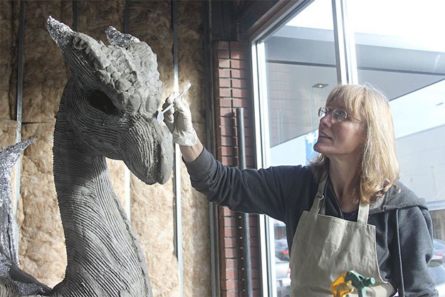 Kim Beaton works on “Brienne” the dragon Tuesday in preparation for this weekend’s first-ever Renton City Comic Convention.