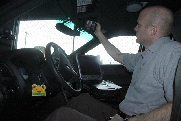 Det. Chris Edwards demonstrates how police use the camera system mounted in their vehicles.
