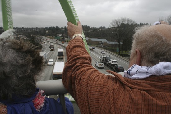 Rod Stewart of Renton was among a crowd of about 40 Seahawks fans who waved to the team's buses from I-405 overpasses in Renton as they made their way to Seattle-Tacoma International Airport Friday afternoon.