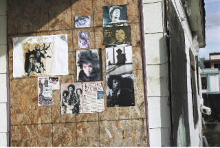 Magazine clippings depicting Jimi Hendrix decorate the boarded-up front of his childhood home on Northeast Fourth Street in the Highlands. The home will likely soon be removed or demolished.