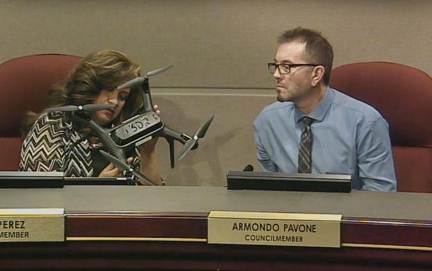 Councilmembers Ruth Perez and Armondo Pavone examine a police drone during the Sept. 26 Committee of the Whole meeting.