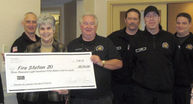 Fire District Chief David Crossen receives a check for almost $4
