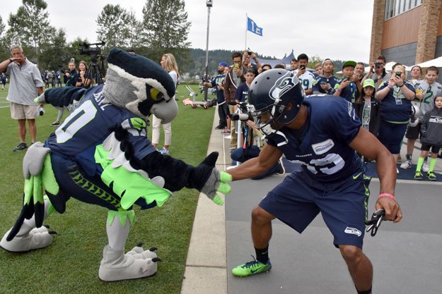 Seahawks mascot Blitz welcomes wide receiver Doug Baldwin to the practice field at the VMAC in Renton this past week.