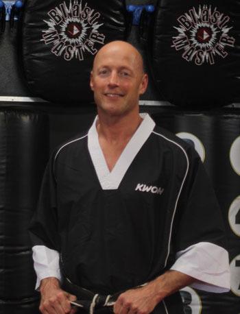 Robert Morrison poses for a photo earlier this year at his martial arts studio in Renton.