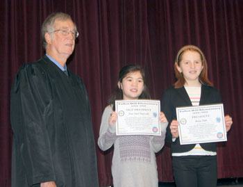 Talbot Hill Elementary's newly elected MicroSociety President Avery Petek (right) and Vice President Cora Supasatit (left) with Judge Robert McBeth on inauguration day.