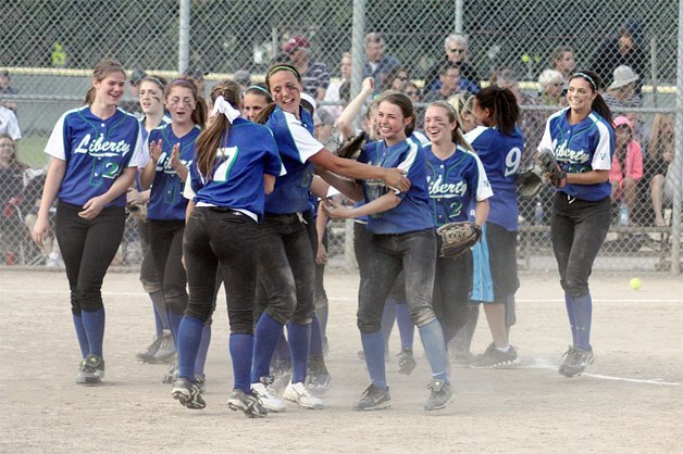 Liberty celebrates after beating Holy Names to clinch a spot in the 3A state tournament.