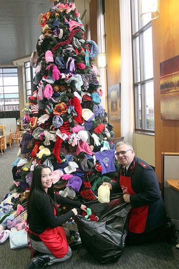 The Salvation Army’s Major Kris Potter and helper collect mittens