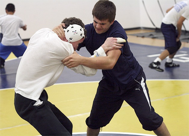 Above: Hazen’s Alex Palanciuc (right) and Daniel Karpman square off during a drill at practice. Left: Austin Clark (right) works on his form in practice.