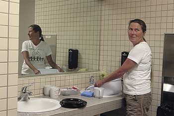 Sonia Hoglander washed her dishes in the men's room at City Hall to protest her water being shut off.