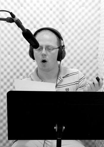 Matt Armstrong narrates a book in the Open Book Audio studio.