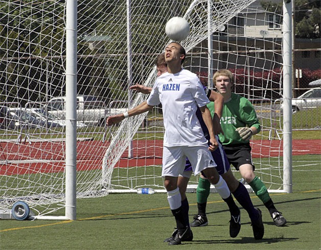 Hazen's Jalen Conway heads in a goal against Columbia River May 12.