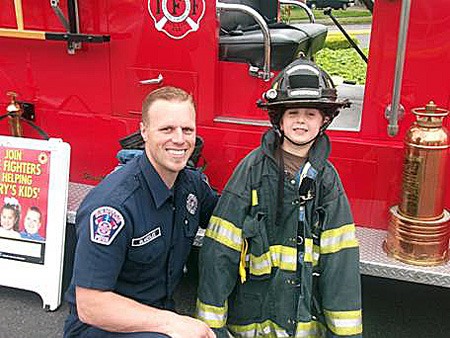 Renton firefighter Nathan Blakeslee gave tours of a fire truck during the Fill The Boot event last Friday and Saturday.