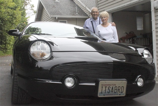 Jim and Joanne Medzegian stand next to their 2002 Ford Thunderbird.