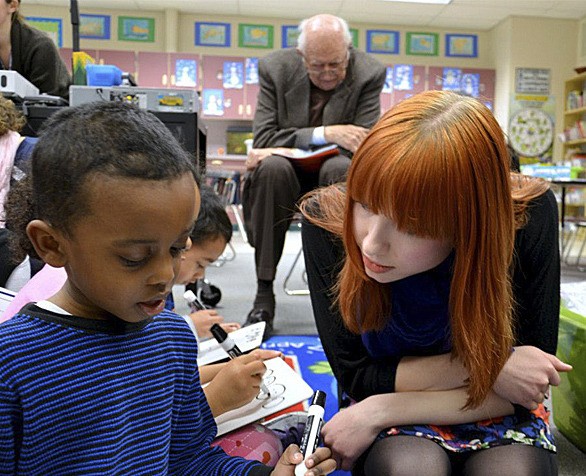 Lakeridge Elementary School kindergarten teacher Candace Abrahamsom works with a student. Bill Gates Sr. is seen behind the two.