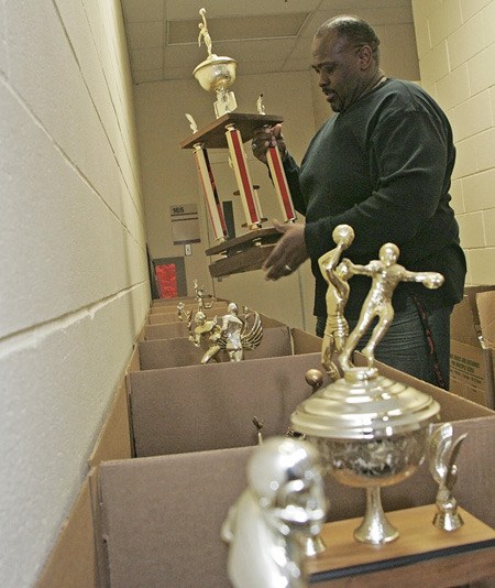 Renton High School Assistant Principal Wendell Ellis goes through and inspects a few of the trophies recently recovered from the school’s tower.