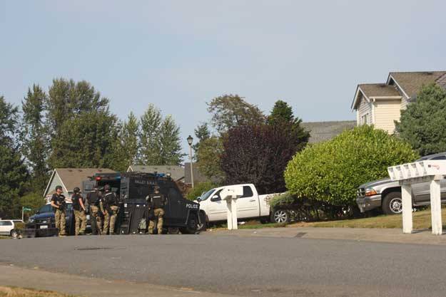SWAT Team members search a house in the Chinquapin neighborhood of Renton.