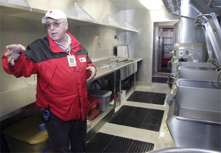 Red Cross mass-care manager Howard Ferrucci leads tours through the Red Cross Mobile Kitchen Tuesday in Renton. The  mobile kitchen will be kept in area in case the Green River floods. It is one of five mobile kitchens in the country used by Red Cross for disaster response.