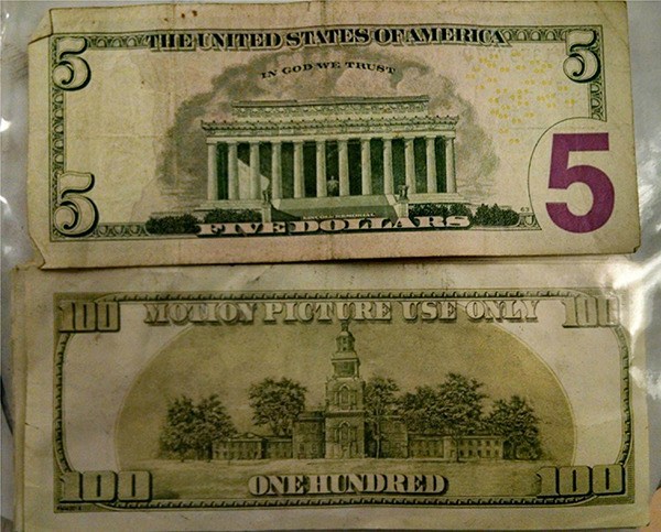 The back of a 'real' $5 shows the correct wording. On the movie prop money