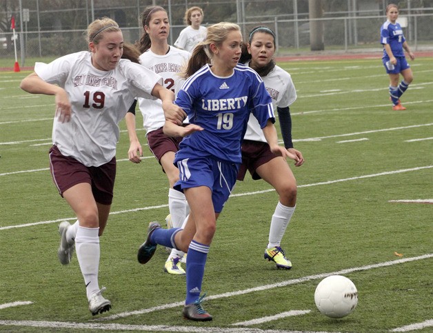 Liberty's Kiana Hafferty brings the ball up the field against Holy Names in the 3A state tournament.