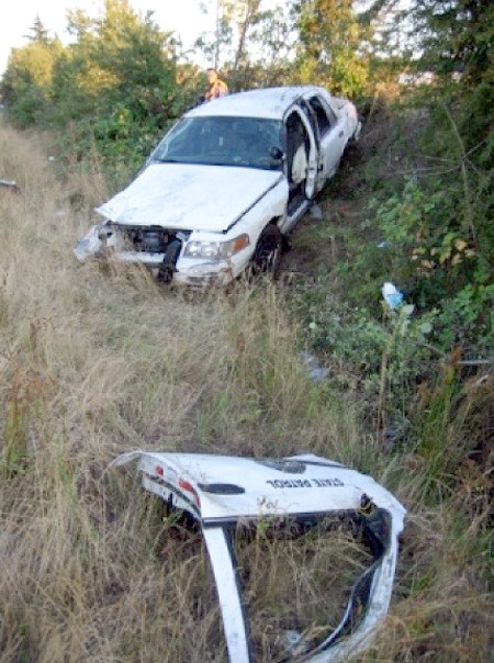 Trooper Brian Salyer's patrol car rolled several times and landed in a ditch off I-5 after he tried to catch up with a group of motorcycles traveling at more than 100 mph Tuesday evening near Southcenter. He was extricated from the car by firefighters.