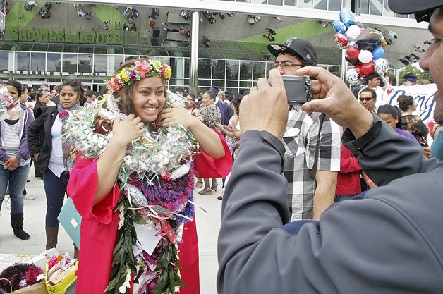 Kisha-Ana Solo poses for her family with a neck full of leis from her family and friends