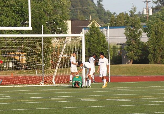 Teammates console Hazen goalie Luis Rodriguez after the winning goal.