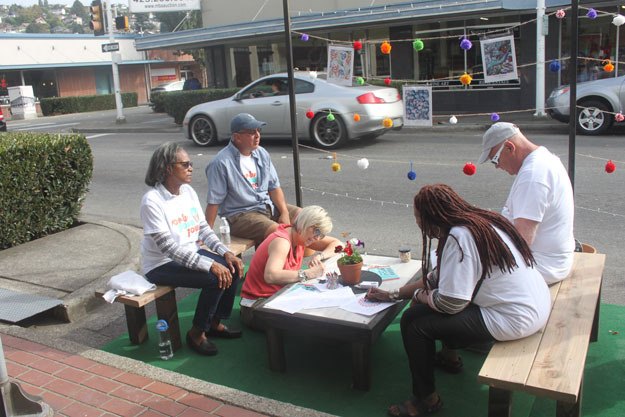 Residents enjoy one of three 'parklets' that appeared downtown Friday as part of the city's Pop-Up Downtown celebration.