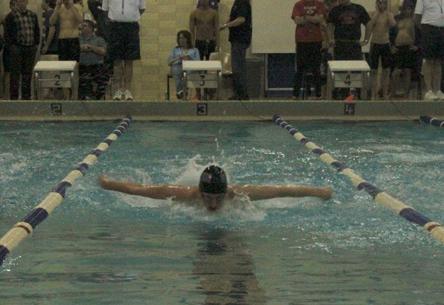 Hazen's Malcom Mitchell swims in the 100-yard butterfly prelims Friday at the 3A district Championship meet. Mitchell finished second overall.