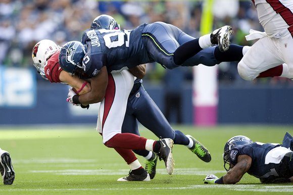 Former Seahawks defensive end Lawrence Jackson flies through the air to make a tackle in Week 6 of the 2009 season.