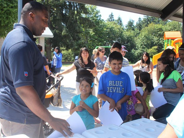Seahawks tackle Russell Okung signed autographs Tuesday at Heritage Park during an appearance to promote the summer lunch program.