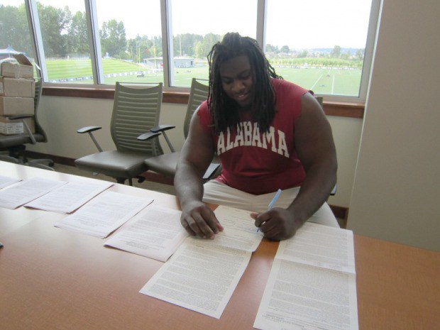 First-round pick James Carpenter signs his contract with the Friday morning at the VMAC.