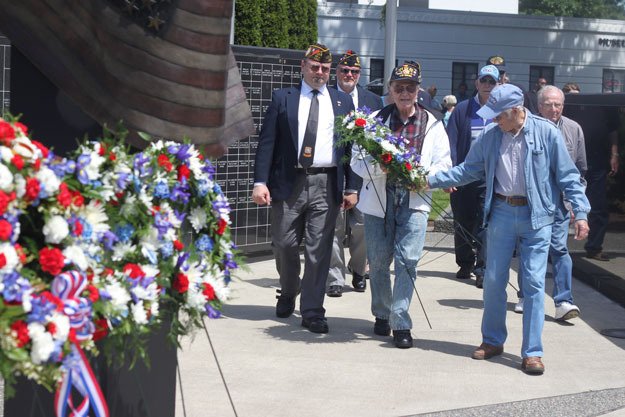 Veterans from the U.S. Navy place a wreath at Veterans Memorial Park on Monday in honor of Memorial Day.