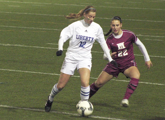 Liberty's Cassidy Nangle dribbles away from a Mercer Island defender Oct. 26.