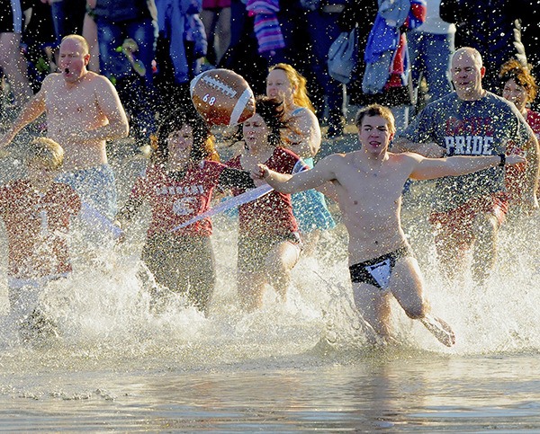 Football even managed to find its way into the annual Polar Bear Dip in Lake Washington on Jan. 1 at Gene Coulon Memorial Beach Park. Dozens braved the chilly water of the lake – and one (below) sported the warrior look and colors of  the 12th Man.