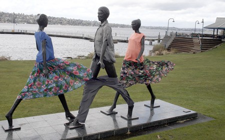 The famous 'Interface' sculpture crafted by Philip Levine in 1984 at Gene Coulon Memorial Beach Park is often dressed appropriately for the season. But the three in their spring attire got caught in Friday's nasty windstorm. And the man got caught with his pants down.