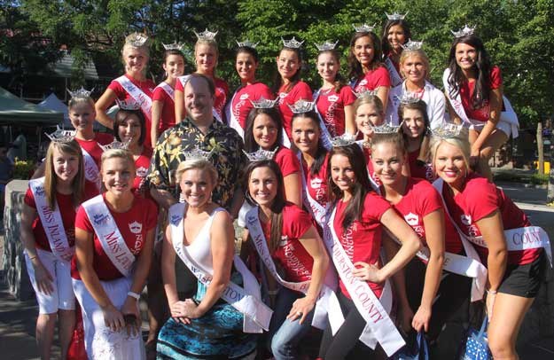 The Miss Washington contestants pose with Cugini Florist owner and pageant sponsor Bill Gaw Tuesday at the Renton Farmer's Market.