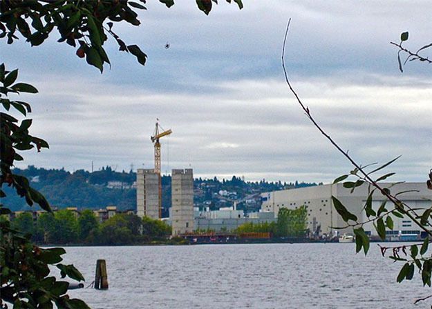 A lot of building is going on near Lake Washington in Renton in this photograph: a spider is weaving at the top center and the new SECO hotel development is rising on the south shore.