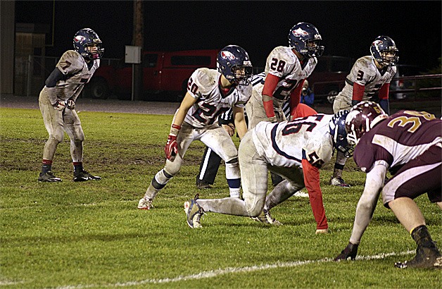 Lindbergh's Cam Callen (7) and the rest of the Eagle defense try to stop Lakewood in muddy conditions.