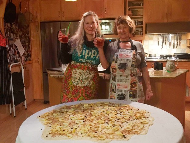 Columnist Carolyn Ossorio and Helga Jacques share a toast before rolling up Helga's Austrian Apple Strudel.