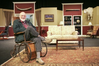 Norm Abrahamson sits onstage at Carco Theatre