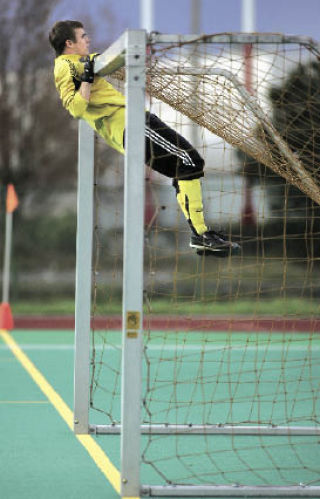 Hazen goalie Drey Hicks does a pull-up on the goal before the start of the second half of a game Friday against Lindbergh at Renton Memorial Stadium. Hicks