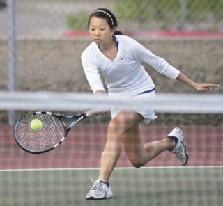 Hazen’s Melissa Nguyen hits a forehand in her singles match against Evergreen’s Tammy Do on Tuesday. Nguyen won the match 6-4