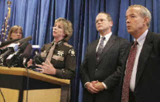 Sheriff Sue Rahr speaks last Thursday during a press conference in Seattle about the proposed cuts to the criminal-justice system in the 2009 King County budget. With her are